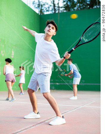 Sports active man during friendly doubles couple match. Two men playing frontenis together outdoor 96472836
