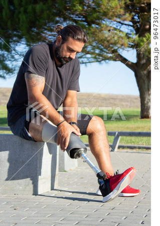 Portrait of man with disability preparing for training outdoors 96473017
