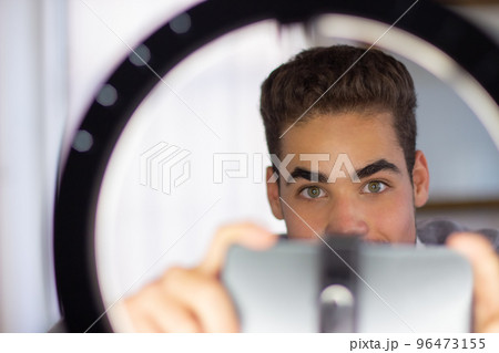 Close-up of young man preparing to record his video blog 96473155