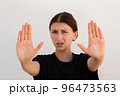 Portrait of displeased young woman making denial gesture 96473563