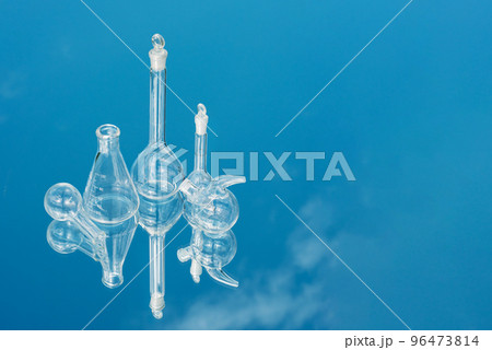 Various laboratory glassware on a mirror background with sky reflection 96473814