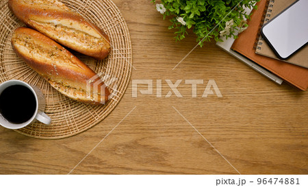 Wooden tabletop background with copy space, coffee cup, baguette and decor. top view Wooden tabletop background with copy space, coffee cup, baguette and decor. top view 96474881