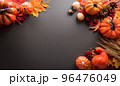 Thanksgiving and Autumn decoration concept made from autumn leaves and pumpkin on dark background. Flat lay, top view with copy space. 96476049