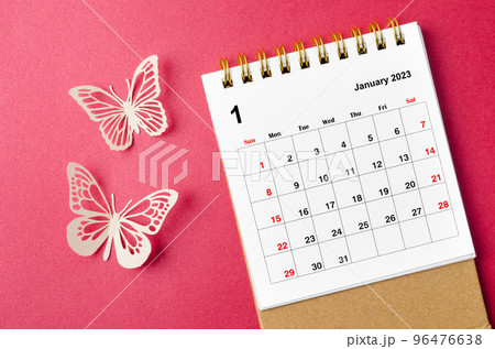 A January 2023 desk calendar for the organizer to plan and reminder with paer butterfly on red background. 96476638