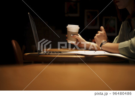 Close up hand asian woman holding pen in casual clothes working in cafe with laptop. Close up hand asian woman holding pen in casual clothes working in cafe with laptop. 96480486
