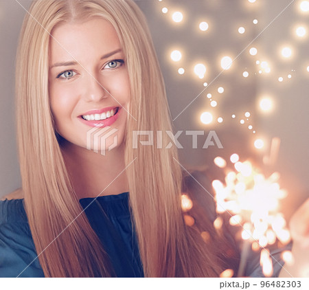 Holiday magic, Christmas and New Year celebration, happy woman with sparklers, portrait Holiday magic, Christmas and New Year celebration, happy woman with sparklers, portrait 96482303