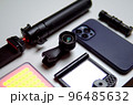Equipment for shooting video on a smartphone. Microphone, LED lamp, tripod, lens smartphone are on a white table 96485632