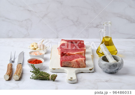 Raw beef eye of round steak on white wooden cutting board Raw beef eye of round steak on white wooden cutting board 96486033