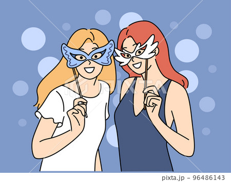 Smiling girls in masks enjoy party 96486143