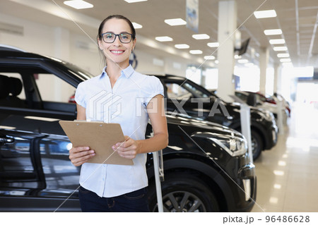 Female marketer making presentation of new cars Female marketer making presentation of new cars 96486628