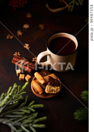 Mug of hot chocolate and Christmas decorations Mug of hot chocolate and Christmas decorations 96487358