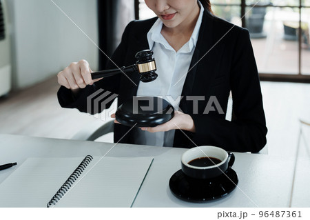 Portrait of a beautiful Asian lawyer studying a lawsuit for a client before going to court. 96487361