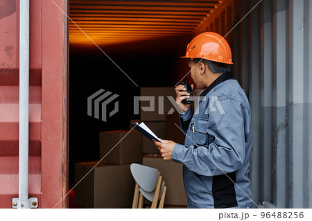 Female worker at shipping dock Female worker at shipping dock 96488256