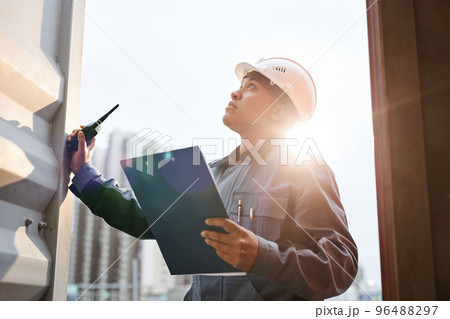 Dock worker in sunlight 96488297