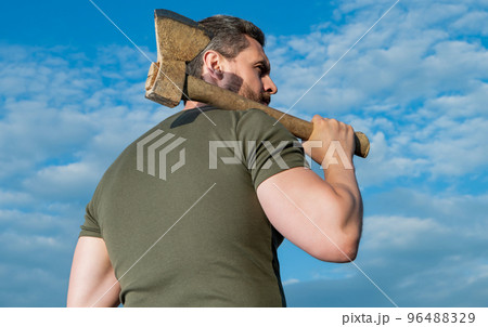 back view of man with axe. lumberjack man hold ax. brutal man on sky background 96488329