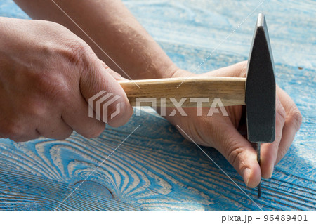 hand hammer a nail hand hammer a nail 96489401