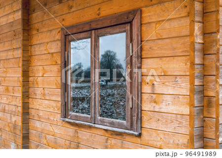Perspective view to window of wooden house 96491989