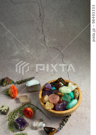 various gem stones in a wooden bowl 96493333