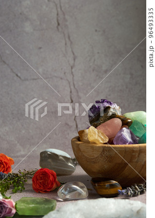 various gem stones in a wooden bowl various gem stones in a wooden bowl 96493335