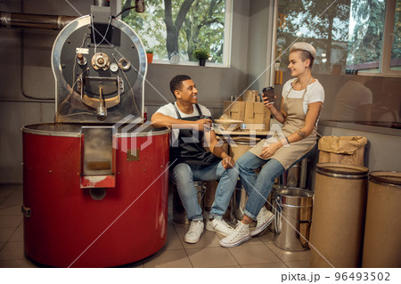 Couple enjoying their coffee break in the workplace Couple enjoying their coffee break in the workplace 96493502