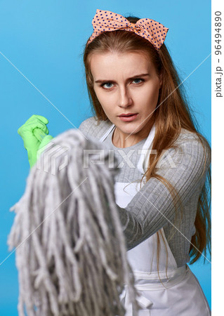 woman in rubber gloves and cleaner apron holding mop woman in rubber gloves and cleaner apron holding mop 96494890