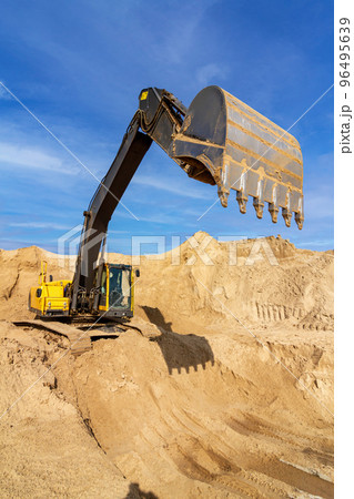 Yellow excavator working with sand at construction site Yellow excavator working with sand at construction site 96495639