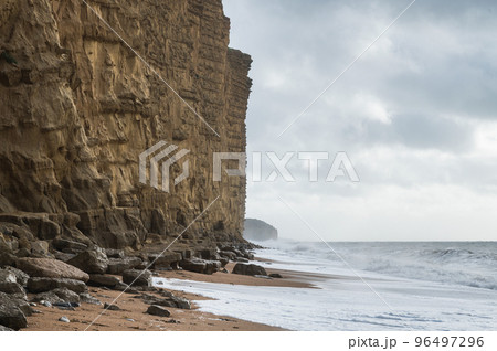 Rock formations, sandstone cliffs in West Bay beach, located near Bridport in Dorset, United Kingdom. Part of famous Jurassic coast, World Heritage Site, selective focus Rock formations, sandstone cliffs in West Bay beach, located near Bridport in Dorset, United Kingdom. Part of famous Jurassic coast, World Heritage Site, selective focus 96497296