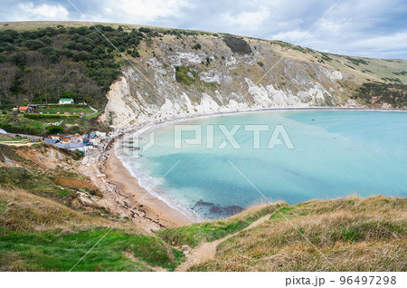 Beautiful views of Lulworth Cove in Dorset, United Kingdom. Part of Jurassic Coast World Heritage Site, view of stone cliffs and blue sea, selective focus Beautiful views of Lulworth Cove in Dorset, United Kingdom. Part of Jurassic Coast World Heritage Site, view of stone cliffs and blue sea, selective focus 96497298
