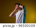 Young man listening to music with headphones 96500109