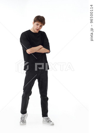 young man in black t-shirt and jeans dancing 96500114