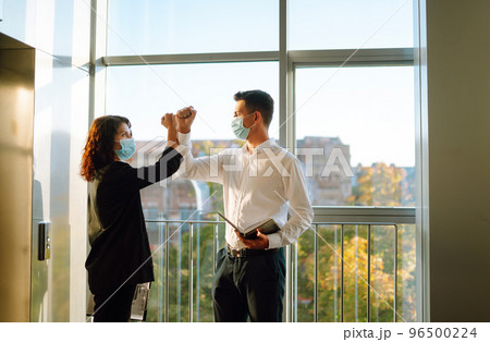 Elbow greeting to avoid the spread of coronavirus. COVID-19. 96500224
