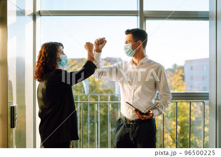 Elbow greeting to avoid the spread of coronavirus. COVID-19. Elbow greeting to avoid the spread of coronavirus. COVID-19. 96500225