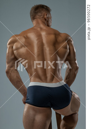 Bodybuilder demonstrates inflated athletic back without face 96500272