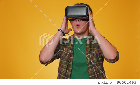 Man using virtual reality futuristic technology VR headset helmet to play simulation 3D video game 96501493