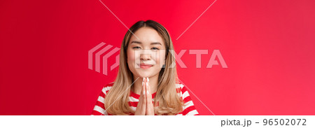 Thankful cute happy asian girl bowing politely show namaste gesture gladful. Joyful attractive blonde hold hands pray appreciate help begging favour, stand relaxed outgoing red background Thankful cute happy asian girl bowing politely show namaste gesture gladful. Joyful attractive blonde hold hands pray appreciate help begging favour, stand relaxed outgoing red background 96502072