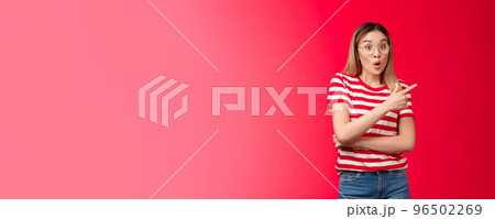 Impressed outgoing good-looking blond asian girl gasping wondered say wow surprised pointing upper right corner intrigued discuss awesome new trends stand red background astonished Impressed outgoing good-looking blond asian girl gasping wondered say wow surprised pointing upper right corner intrigued discuss awesome new trends stand red background astonished 96502269