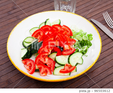 Appetizing cucumber and tomato salad closeup 96503612
