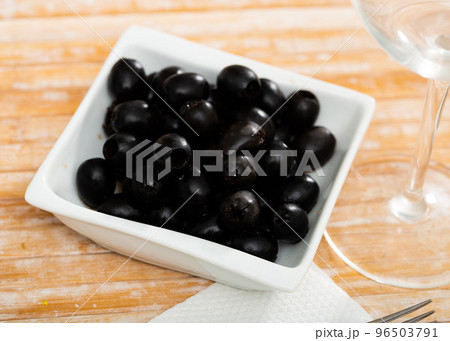 Pickled black olives in white bowl 96503791