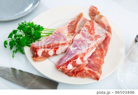 Raw pork ribs ready for cooking on cutting wooden board 96503896