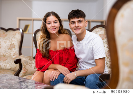Portrait of loving family couple sitting in comfy home room Portrait of loving family couple sitting in comfy home room 96503980