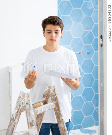 Young man owner is shocked by the estimate for the renovation of cottage Young man owner is shocked by the estimate for the renovation of cottage 96504232