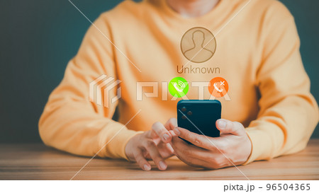 Man answering to incoming call. Phone call from unknown number. Call center gang, scammer or stranger. Hoax person with fake identity. Scam, fraud or phishing with mobile phone or smartphone concept. 96504365