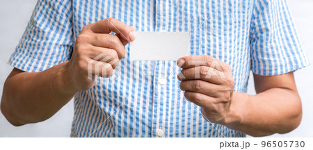 Man holding a white business card. 96505730