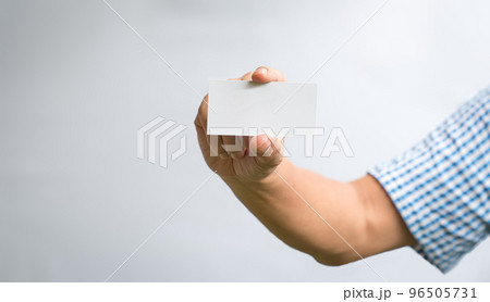 Man holding a white business card. 96505731