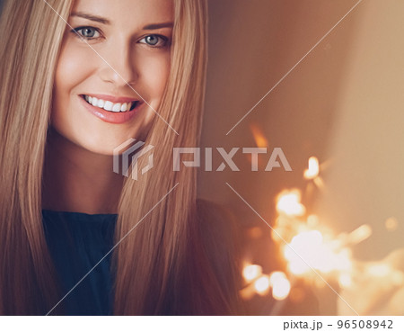 Holiday magic, Christmas and New Year celebration, happy woman with sparklers, portrait Holiday magic, Christmas and New Year celebration, happy woman with sparklers, portrait 96508942