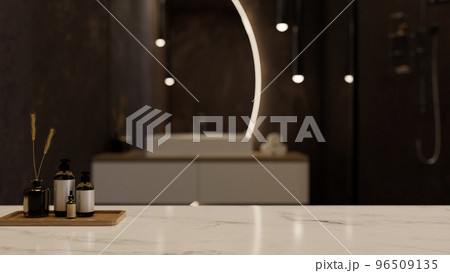 White marble tabletop with bath accessories set and copy space over blurred modern luxury bathroom White marble tabletop with bath accessories set and copy space over blurred modern luxury bathroom 96509135