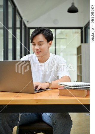 Portrait, Handsome and smart Asian male doing his project, using laptop computer. 96509637