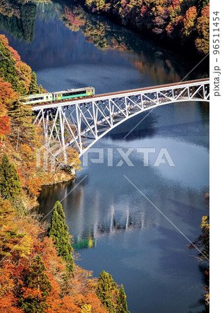 只見線　秋の第一只見川橋梁を渡る列車「キハE120形＋キハ110系」(福島県三島町、11月) 96511454