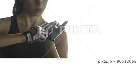 Woman put fitness gloves  for exercise at gym. 96512068