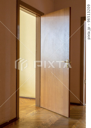 A fragment of the interior of a corridor with an open door 96513209